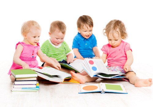 Babies looking at books and learning shapes and colors at Infant Daycare in Peoria IL