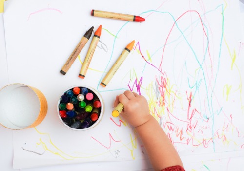 A child drawing with crayons at a Day Care in Peoria IL