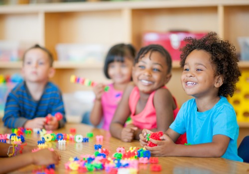 Happy and smiling children playing with toys at a day care in Peoria IL