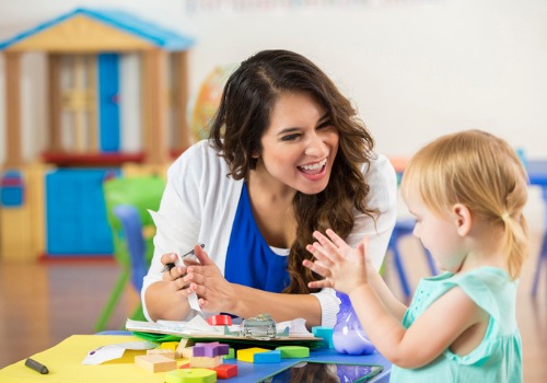 A teaching talking with a child at the Best Daycare Peoria IL