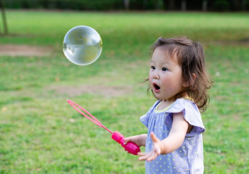 A child playing with bubbles at a Infant Day Care in Peoria IL