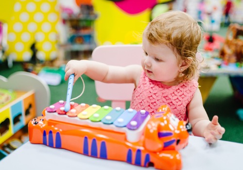 Baby Girl Making Music at Infant Care for Dunlap IL