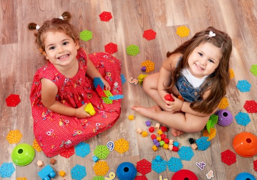 Happy children playing with toys at a Child Development Center in Peoria IL