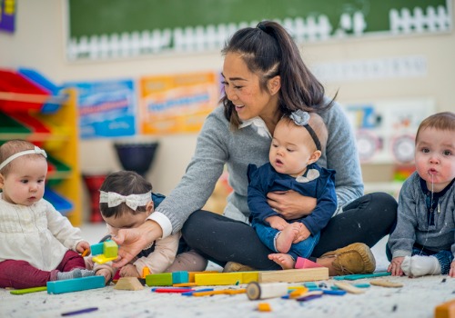 a pre-school teacher plays with babies at PALS, the Best Infant Care in Peoria County IL