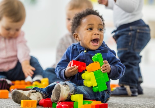 A baby plays with plastic blocks at PALS, which offers Infant Care Near You