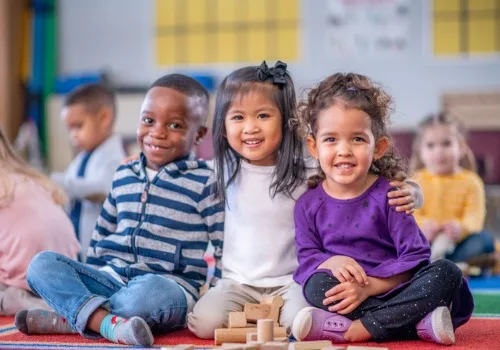 A group of kids at PALS, one of the top Preschools Near Metamora IL, smile for the camera.