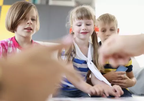 Children watch a teacher at PALS, which has built a foundation of learning based upon several major research such as Howard Gardner’s Multiple Intelligence Theory.