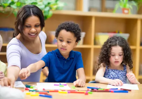 A teacher works with children at PALS, which offers outstanding options for Pre K in Peoria IL