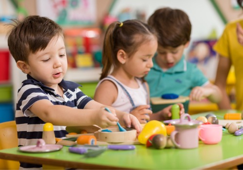 Children play with clay in their classroom at PALS Praise & Leadership Schools, a top Child Care Center in Peoria IL