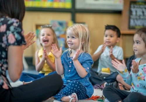 Children clap and laugh as their teacher leads them in a song at PALS Praise & Leadership Schools, a top Child Care Center in Peoria IL