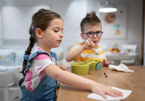 Toddlers clean up after themselves at lunch, which is a great way people can start teaching Kids Good Manners from a young age